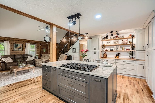 kitchen featuring open floor plan, black gas stovetop, and light wood-type flooring