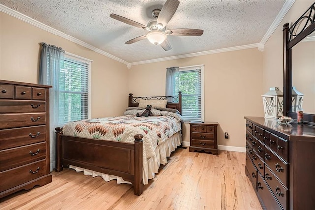 bedroom featuring baseboards, a textured ceiling, light wood-style flooring, and ornamental molding
