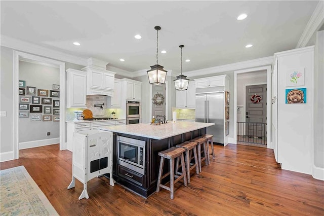829 Christopher Rd, Sharpsburg, GA 30277 - kitchen featuring built in appliances, decorative backsplash, a breakfast bar, white cabinets, and recessed lighting