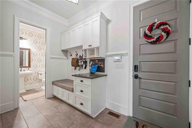 829 Christopher Rd, Sharpsburg, GA 30277 - mudroom with ornamental molding and light tile patterned floors
