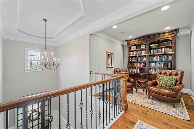 829 Christopher Rd, Sharpsburg, GA 30277 - sitting room with an upstairs landing, crown molding, a chandelier, wood finished floors, and recessed lighting