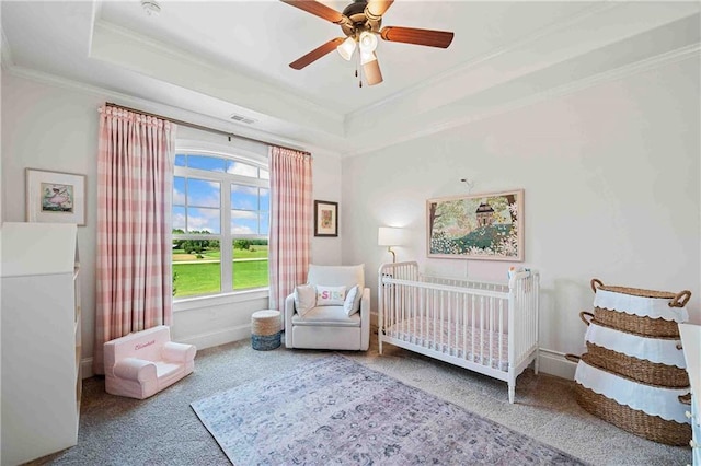 829 Christopher Rd, Sharpsburg, GA 30277 - carpeted bedroom with ornamental molding, a raised ceiling, a crib, baseboards, and a ceiling fan