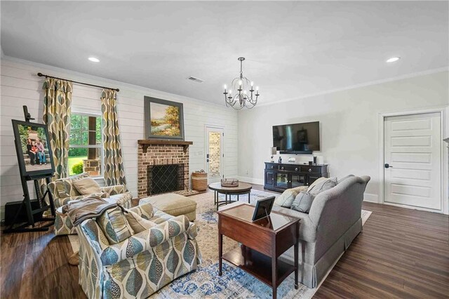829 Christopher Rd, Sharpsburg, GA 30277 - living area with crown molding, dark wood-style flooring, a chandelier, baseboards, and a brick fireplace