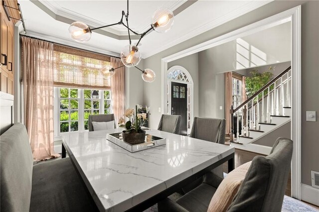 3749 Watkins Pl NE, Brookhaven, GA 30319 - dining room featuring ornamental molding, a chandelier, stairway, and a tray ceiling