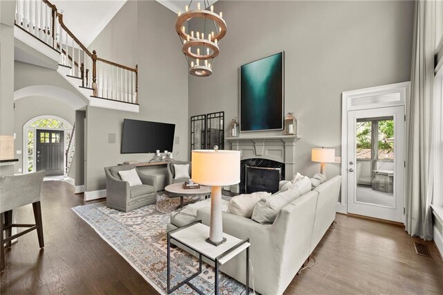 3749 Watkins Pl NE, Brookhaven, GA 30319 - living area featuring a high ceiling, wood finished floors, a chandelier, plenty of natural light, and baseboards