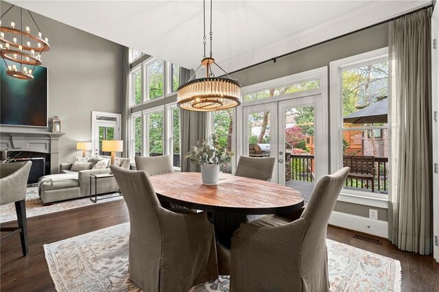 3749 Watkins Pl NE, Brookhaven, GA 30319 - dining room featuring a chandelier, french doors, a fireplace, and dark wood finished floors