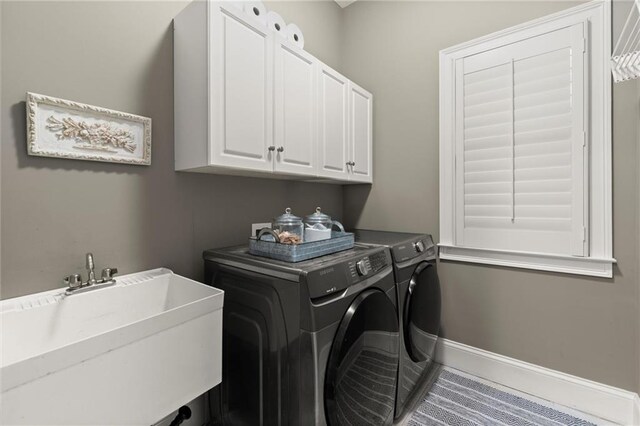 3749 Watkins Pl NE, Brookhaven, GA 30319 - laundry area featuring separate washer and dryer, cabinet space, and baseboards