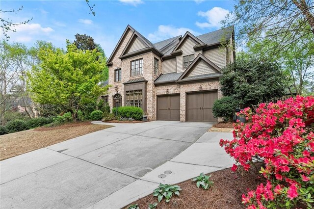 3749 Watkins Pl NE, Brookhaven, GA 30319 - view of front facade featuring concrete driveway, a garage, and brick siding