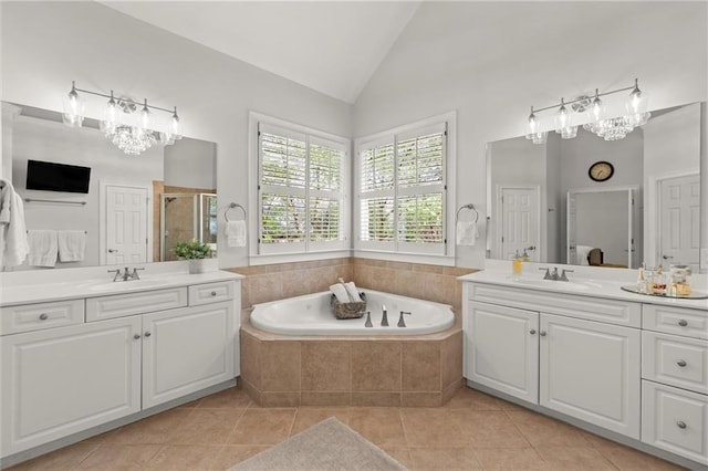 3749 Watkins Pl NE, Brookhaven, GA 30319 - bathroom featuring two vanities, tile patterned flooring, a garden tub, high vaulted ceiling, and a shower stall