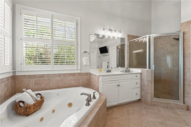 3749 Watkins Pl NE, Brookhaven, GA 30319 - full bathroom with vanity, a tub with jets, a stall shower, and tile patterned flooring