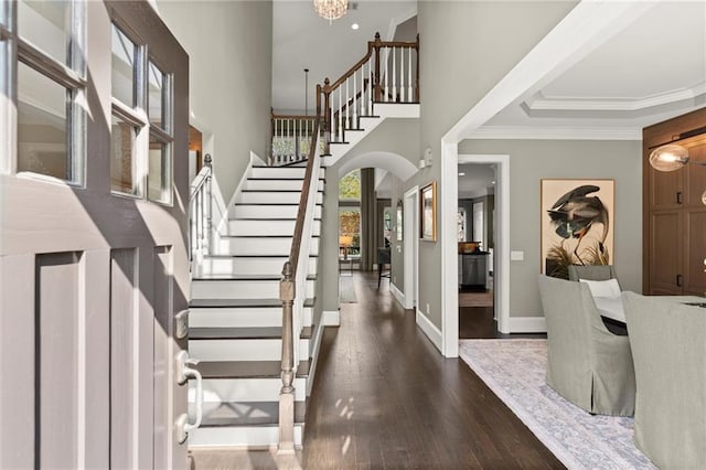 3749 Watkins Pl NE, Brookhaven, GA 30319 - foyer with stairs, arched walkways, dark wood-type flooring, crown molding, and baseboards