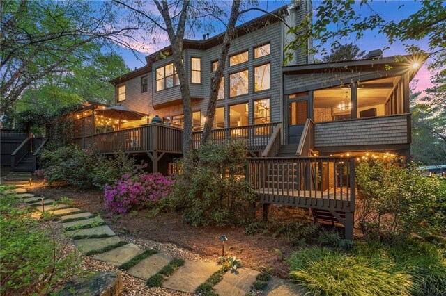 3749 Watkins Pl NE, Brookhaven, GA 30319 - back of property at dusk featuring stairs and a deck