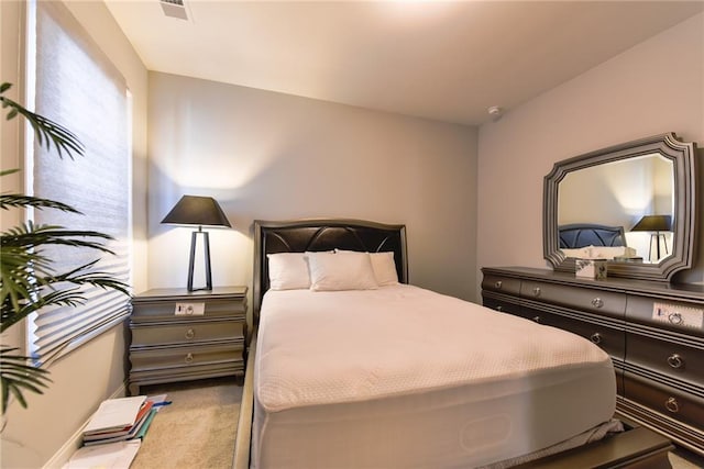 bedroom with visible vents and carpet flooring