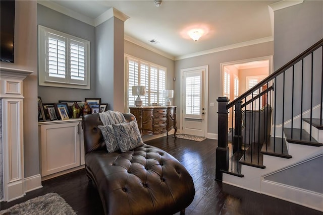 sitting room with stairway, dark wood-style floors, visible vents, crown molding, and baseboards