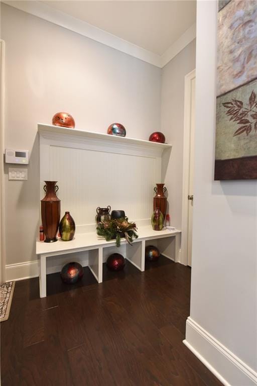 mudroom with baseboards, ornamental molding, and wood finished floors
