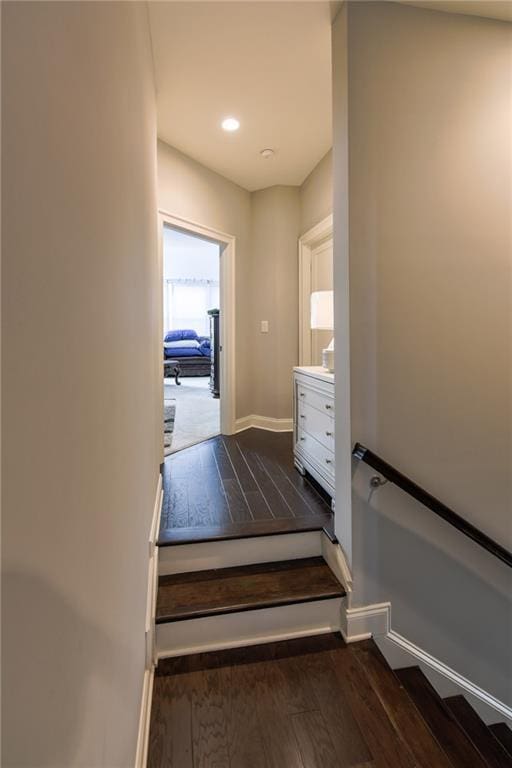 stairs featuring wood-type flooring, baseboards, and recessed lighting