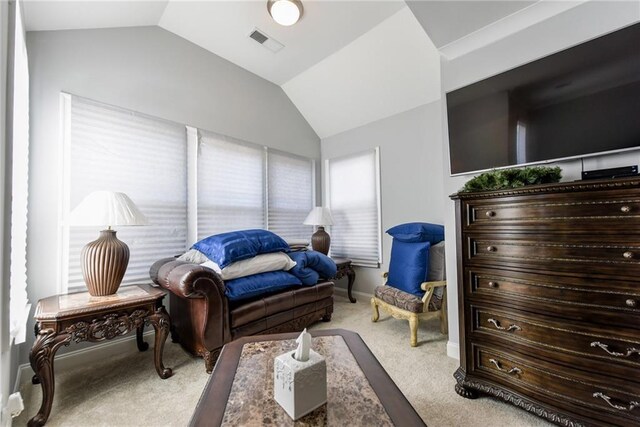living area featuring baseboards, vaulted ceiling, visible vents, and carpet floors