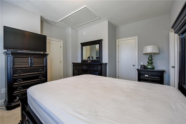 bedroom featuring attic access, baseboards, and carpet flooring