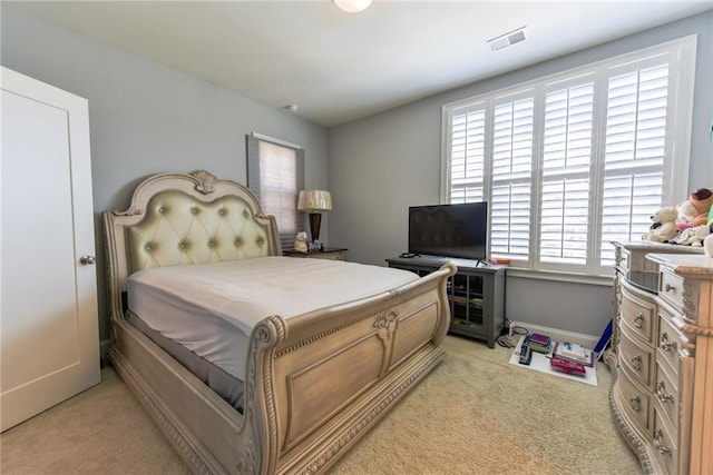 bedroom featuring baseboards, visible vents, light colored carpet, and multiple windows