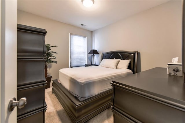 bedroom with light carpet and visible vents