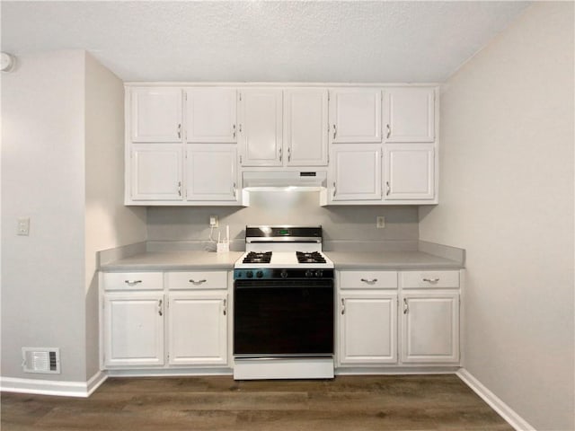 kitchen featuring a textured ceiling, white gas range, dark hardwood / wood-style floors, and white cabinetry