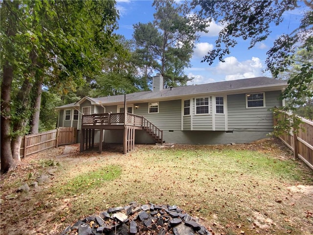 back of property featuring stairs, a fenced backyard, a chimney, and crawl space