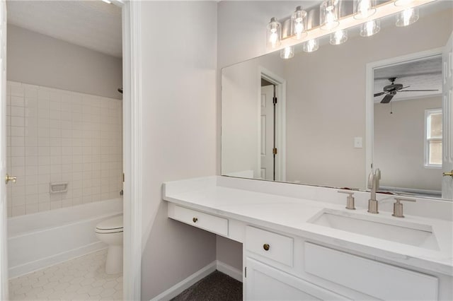 full bathroom with ceiling fan, tiled shower / bath combo, vanity, tile patterned floors, and toilet