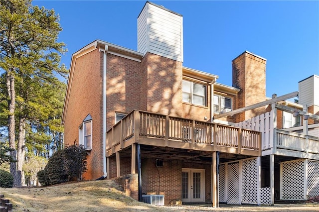 back of property featuring a deck and french doors