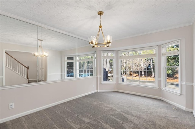 interior space featuring an inviting chandelier, carpet flooring, and a textured ceiling