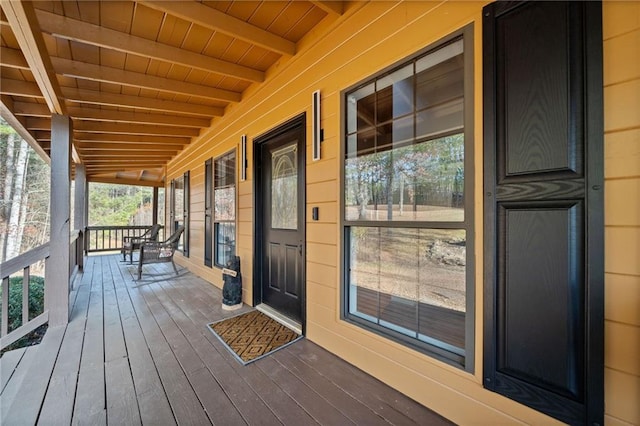 wooden terrace featuring covered porch