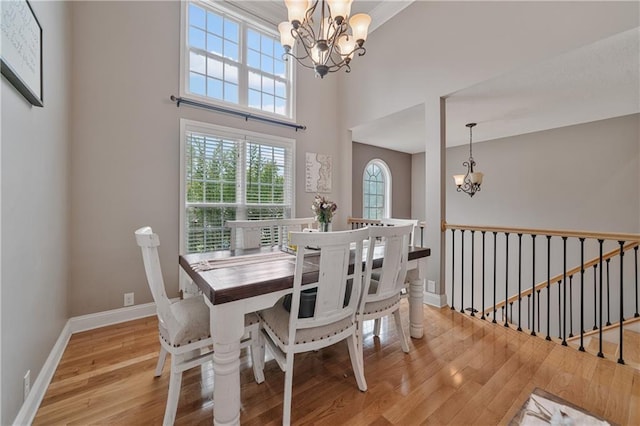 166 Woodford Way SE, Calhoun, GA 30701 - dining room with a chandelier, light wood-style flooring, and baseboards