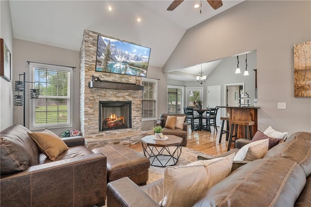 166 Woodford Way SE, Calhoun, GA 30701 - living area featuring ceiling fan, plenty of natural light, a stone fireplace, wood finished floors, and high vaulted ceiling
