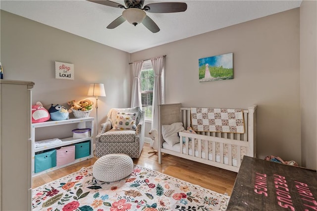 166 Woodford Way SE, Calhoun, GA 30701 - bedroom with a nursery area, wood finished floors, and ceiling fan