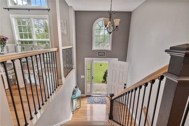 166 Woodford Way SE, Calhoun, GA 30701 - entrance foyer with a chandelier, wood finished floors, plenty of natural light, a high ceiling, and stairway