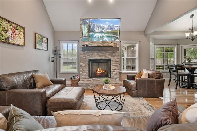 166 Woodford Way SE, Calhoun, GA 30701 - living room featuring vaulted ceiling, light wood-style floors, a stone fireplace, and a chandelier