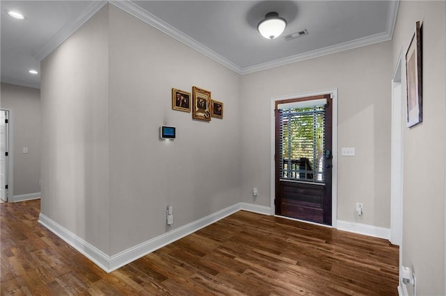 entryway featuring dark wood-type flooring, ornamental molding, and a baseboard radiator