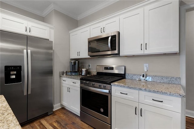 kitchen with stainless steel appliances, ornamental molding, white cabinets, and dark hardwood / wood-style flooring