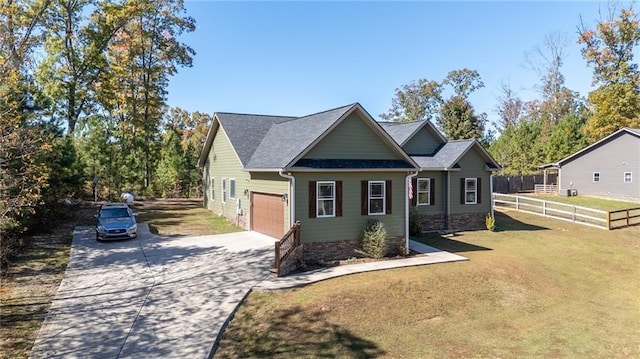 craftsman-style house featuring a garage and a front yard