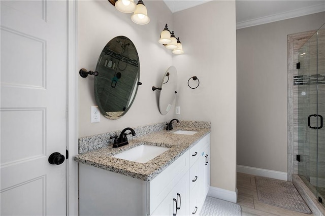 bathroom with walk in shower, vanity, and crown molding