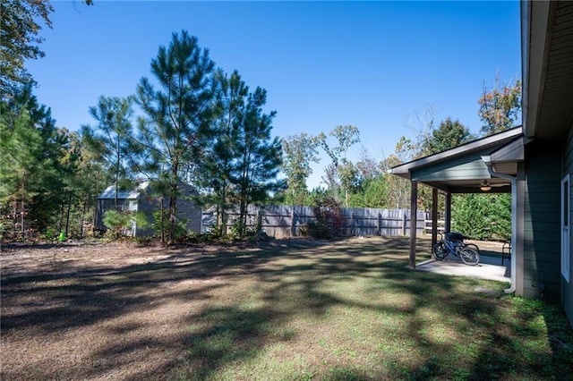 view of yard with a patio area and ceiling fan