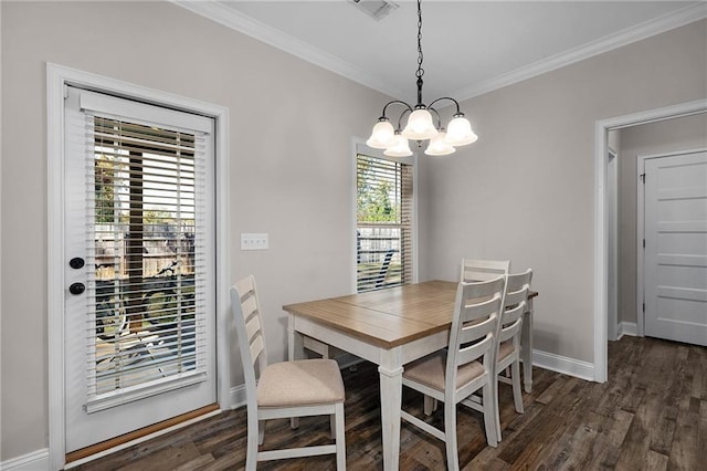 dining space with crown molding, dark wood-type flooring, and a chandelier