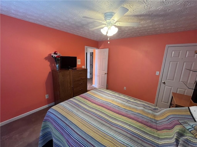 carpeted bedroom with ceiling fan and a textured ceiling