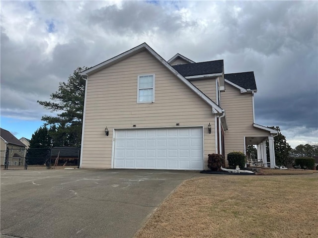 view of front of home with a front yard and a garage