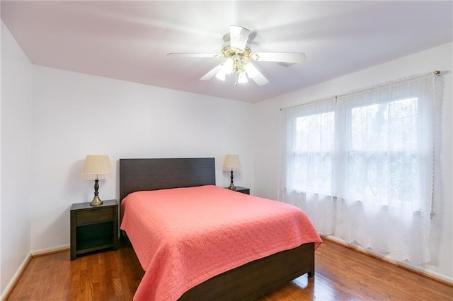 bedroom with ceiling fan and hardwood / wood-style flooring