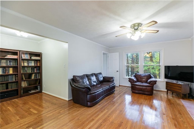 living room featuring ceiling fan, ornamental molding, and hardwood / wood-style floors