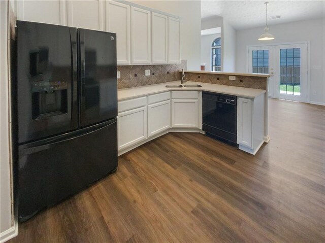 kitchen with backsplash, sink, black appliances, pendant lighting, and white cabinets