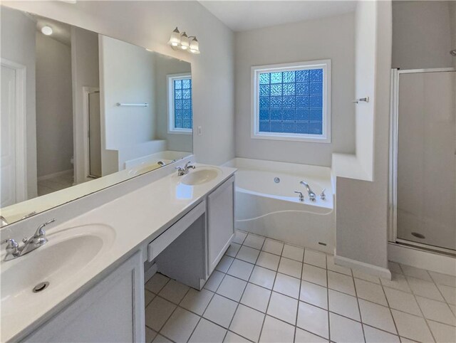 bathroom featuring tile patterned flooring, vanity, and plus walk in shower