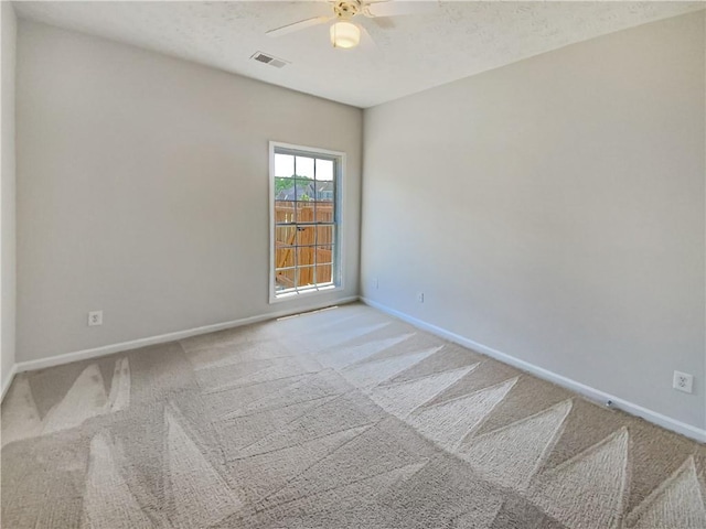 spare room with ceiling fan and carpet floors