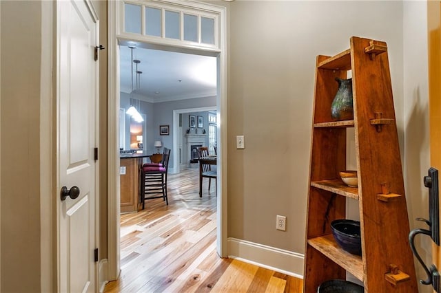 825 Highland Ln Unit 1105, Atlanta, GA 30306 - hallway featuring crown molding, baseboards, and light wood-type flooring