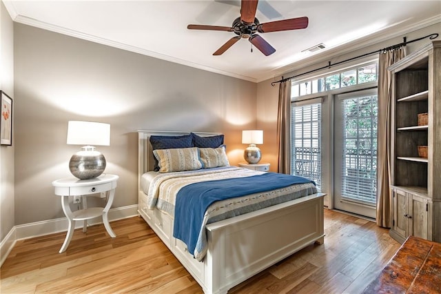 bedroom featuring light wood finished floors, visible vents, ornamental molding, ceiling fan, and baseboards